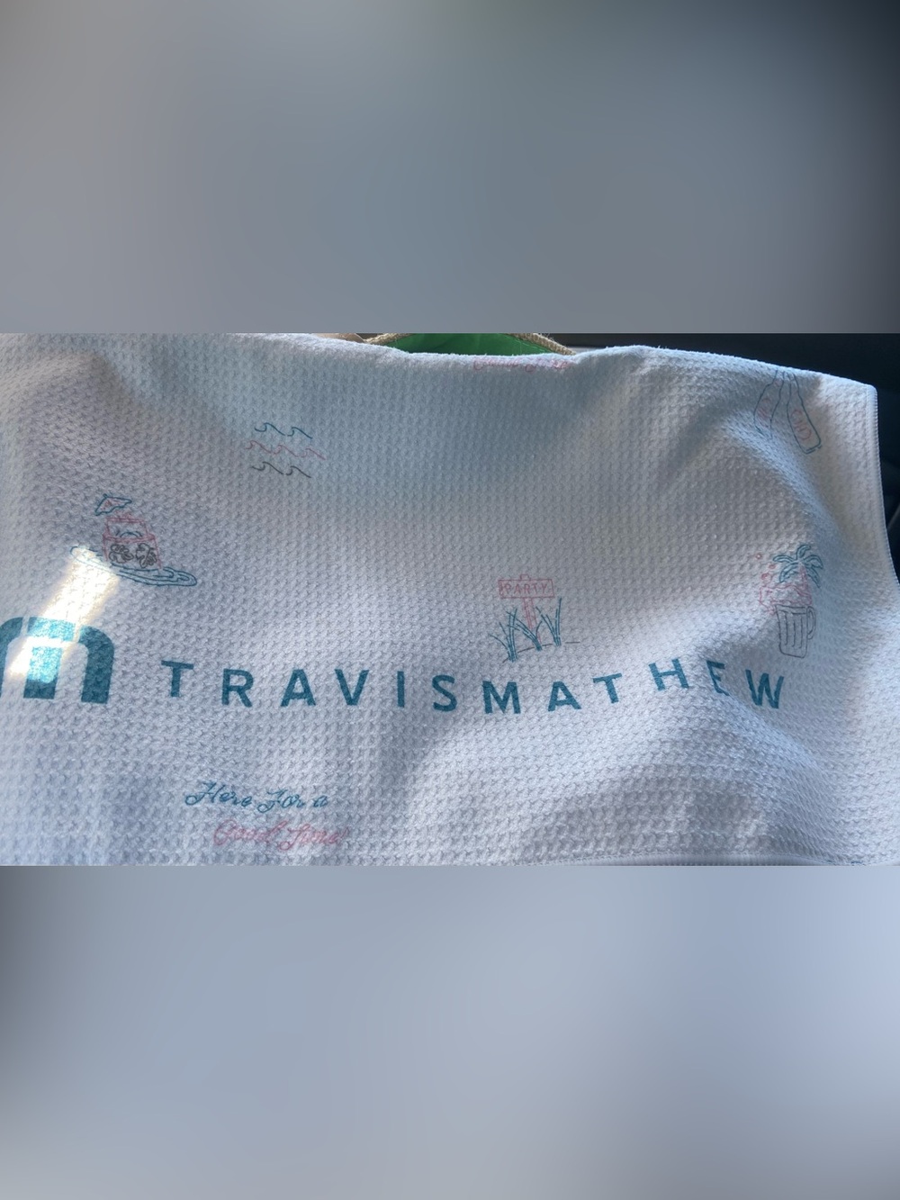 Travis Mathew microfiber golf towel tropical-themed pattern